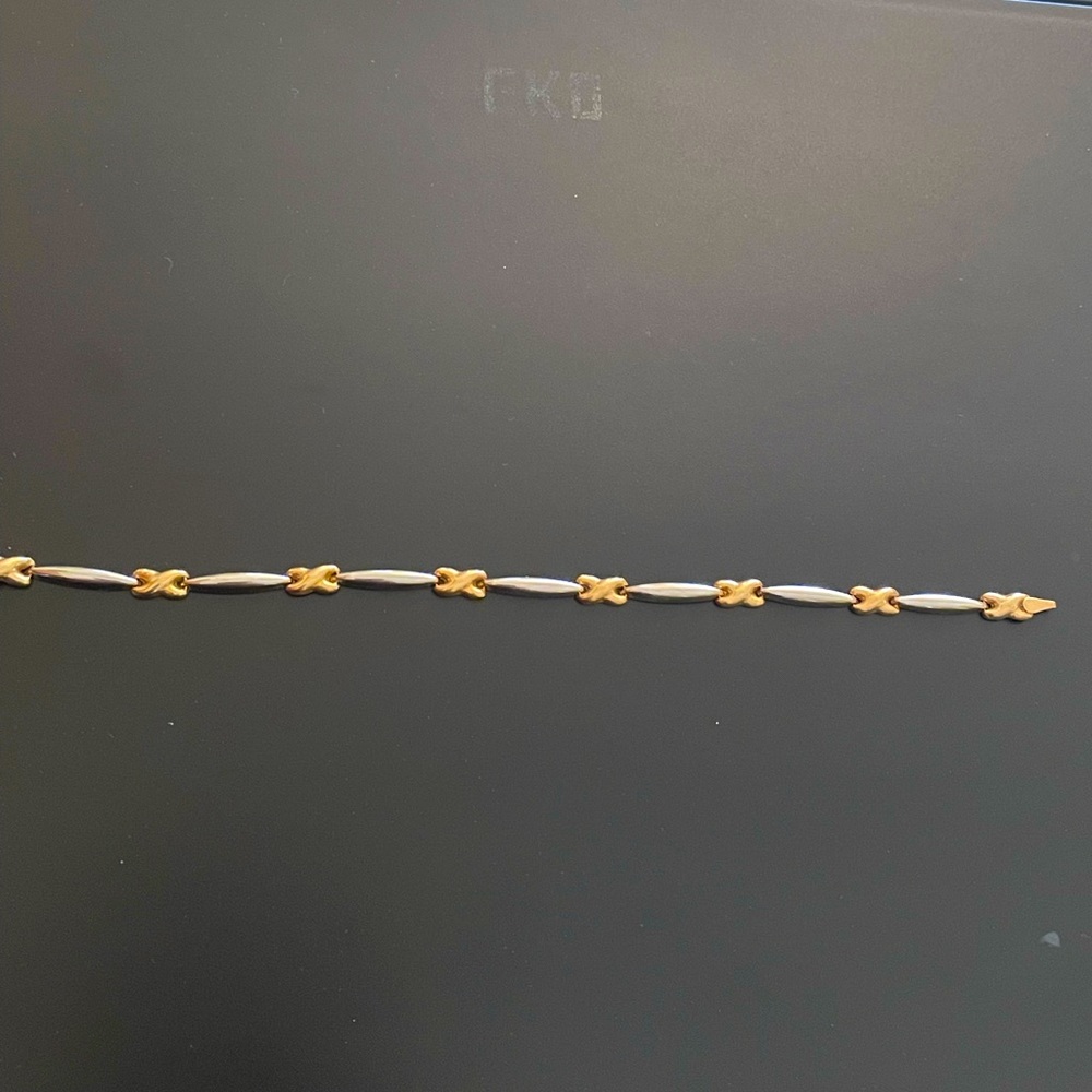 This is a silver colored and gold colored bracelet.